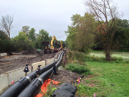 The Council will install temporary above-ground sewer pipes to convey wastewater while working to replace nearly three miles of regional sanitary sewer pipe along Westedge Blvd. and County Road 44. This photo shows a similar project along Highway 101 in Wayzata in 2015.