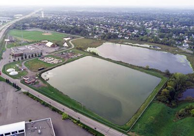 Aerial photo of two large ponds, several buildings, and the aeration ponds at the current Rogers Wastewater Treatment Plant.