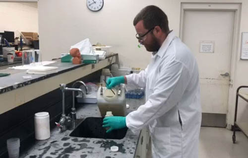 A lab technician pours into a small bottle a sample of the wastewater collected automatically throughout the day at the Metro Plant. Samples are shipped to research projects every week.