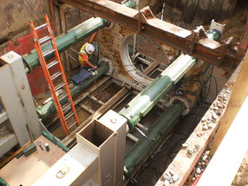 Part of the project entailed digging a tunneling pit to insert a large interceptor pipe underneath railroad tracks.