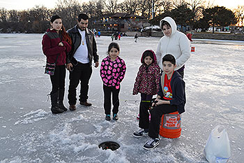 6 people ice fishing.