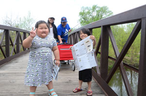 Two children and two adults on a bridge.