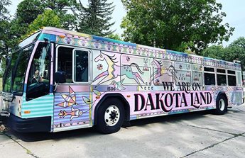 Side view of the We Are On Dakota Land bus.