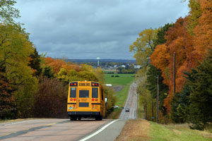 A school bus on a two-lane road.