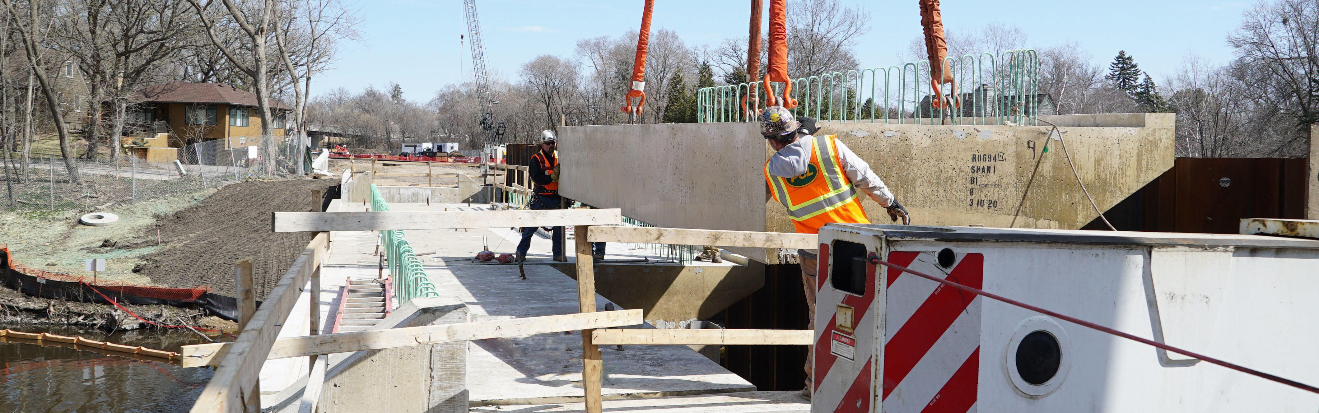 Construction workers install bridge deck at the Cedar Lake Channel