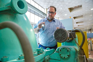 Wastewater plant operator checks equipment in the liquids business unit at the Metro Plant in Saint Paul.
