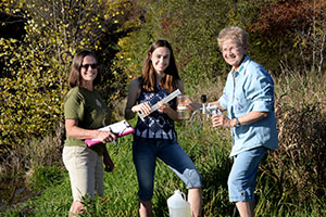 CAMP volunteers pose with sampling equipment in Washington County.