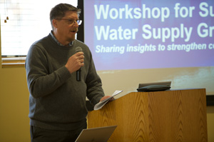 A staff member speaking at a podium during a workshop.