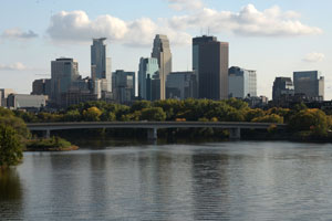 Minneapolis skyline, with the Mississippi River in the foreground.
