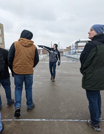 A guide pointing to the left during a tour in the winter.