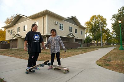 Girls skateboard near their home in Saint Paul.