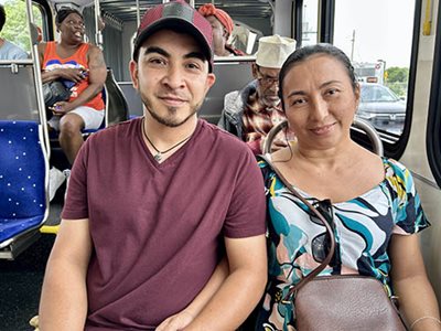Riders enjoy the METRO B Line, part of a robust public transportation system in the Twin Cities metro region that has grown under the leadership of Met Council Chair Charlie Zelle. Two bus riders on the METRO B Line smile for the camera.
