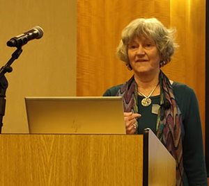 Speaker at a podium with a microphone.