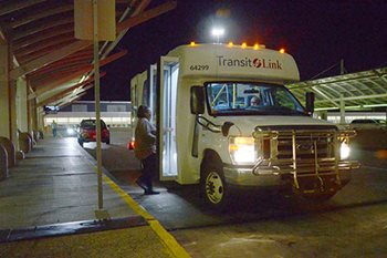 Person boarding a Transit Link bus late in the evening.