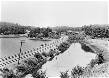 The Great Northern Railroad ca. 1900 crossing north edge of Cedar Lake (Trembley 2012). Black and white photo of the Great Northern Railroad ca. 1900 crossing north edge of Cedar Lake.