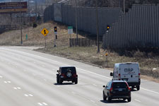 Three vehicles on a multi-lane highway.