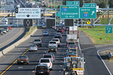 Two lanes of heavy traffic next to a carpool lane.